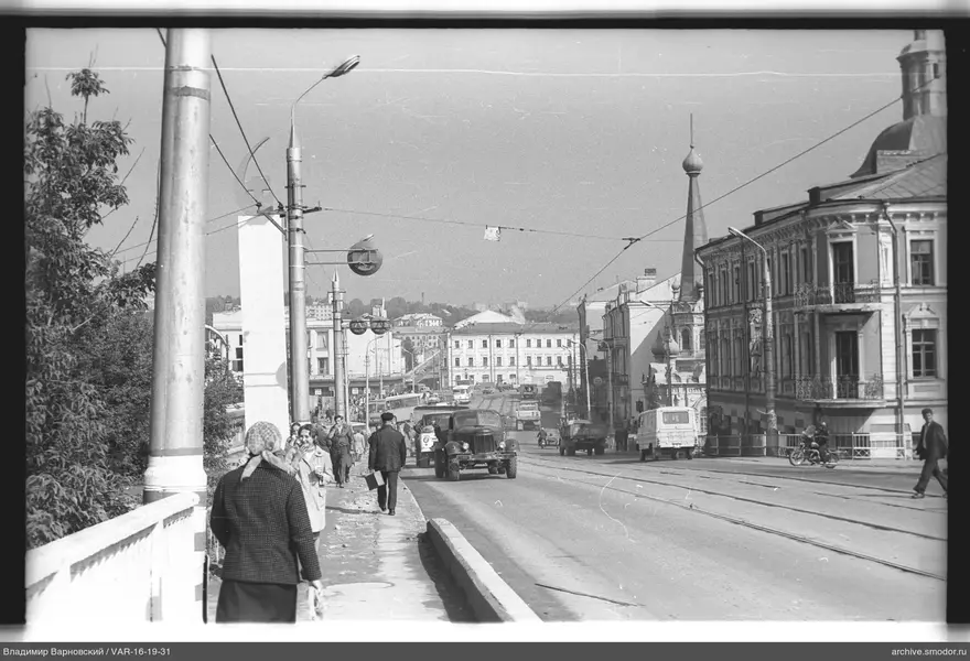 City street with trolleybuses and pedestrians