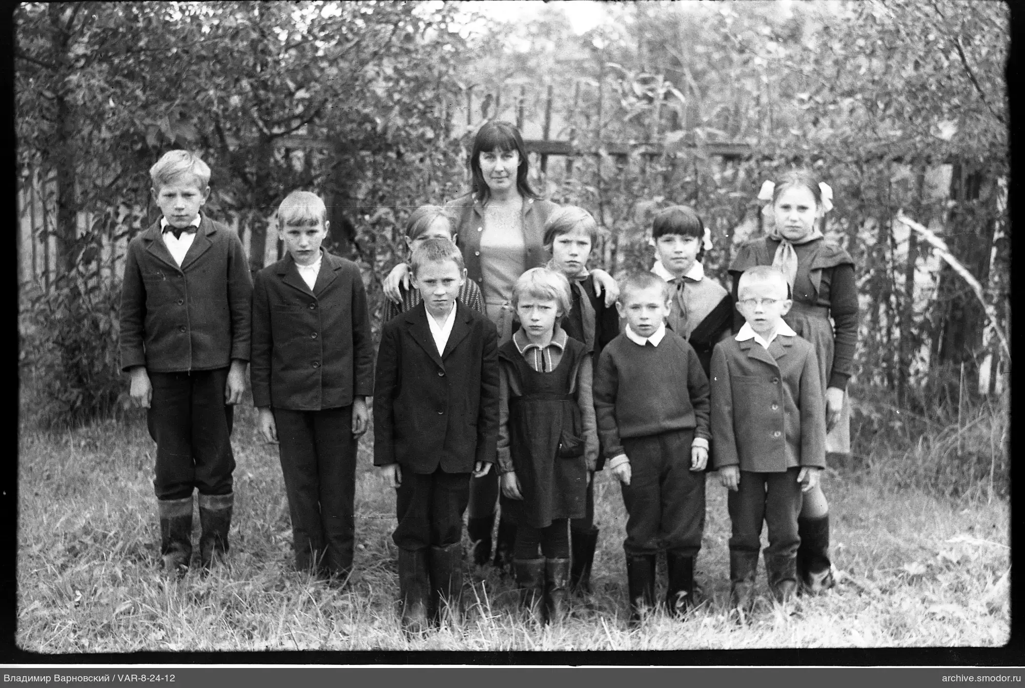 Group portrait of children and woman
