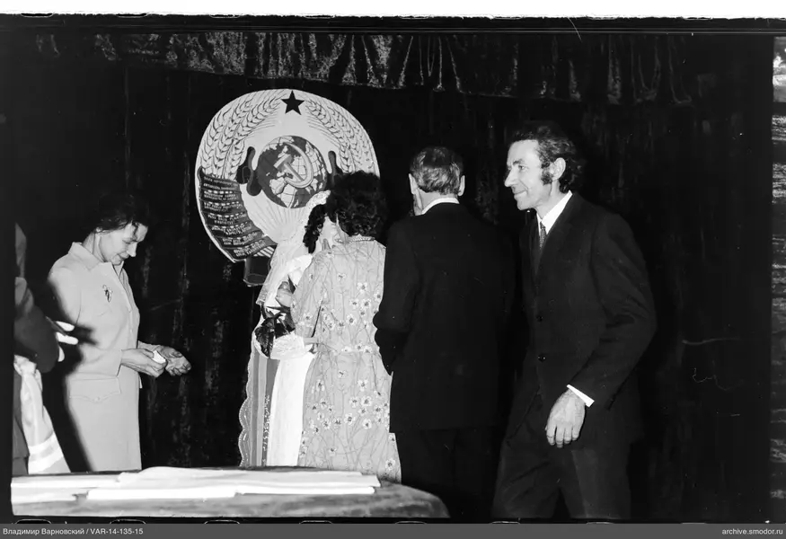 Group of people against USSR emblem curtain