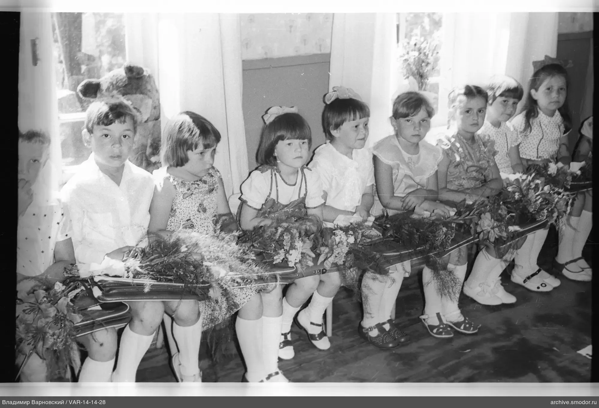 Group portrait of children with bouquets