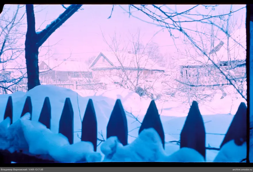 Wooden fence and snowy landscape