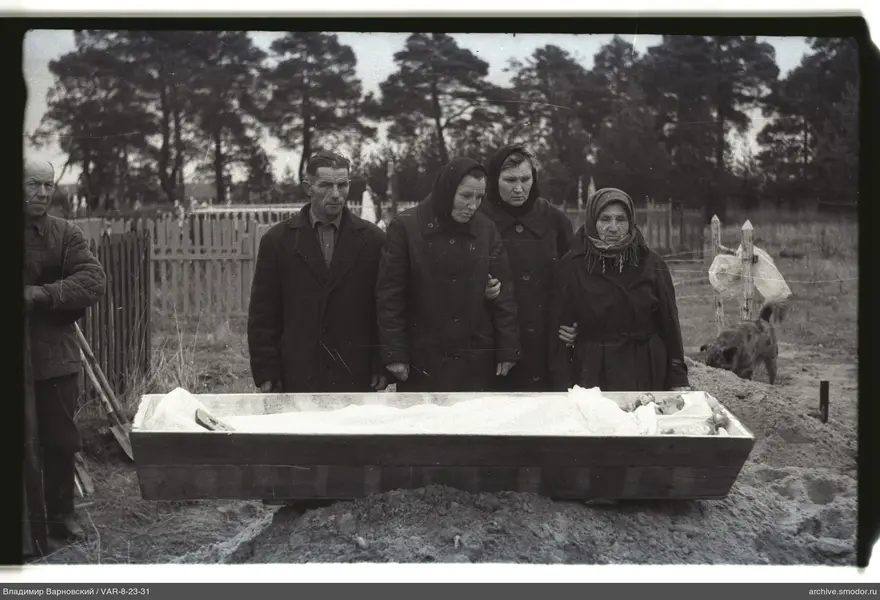 Group portrait by a wooden coffin