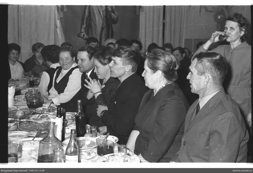 Group sitting at a table with dishes and drinks