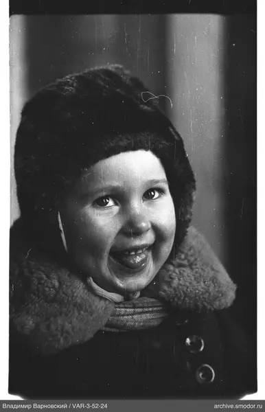 Child's portrait with fur hat and striped scarf