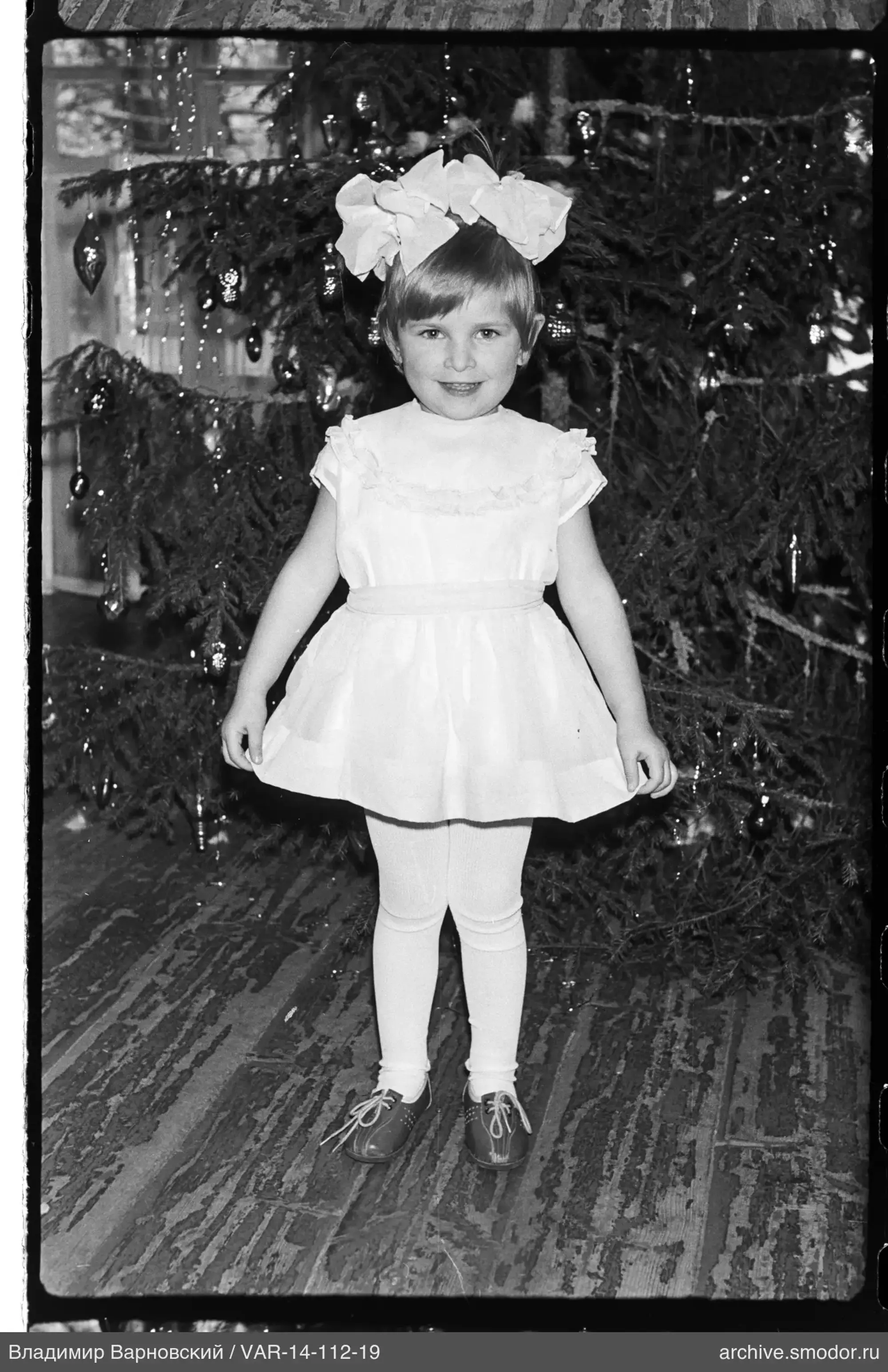 Girl in front of Christmas tree