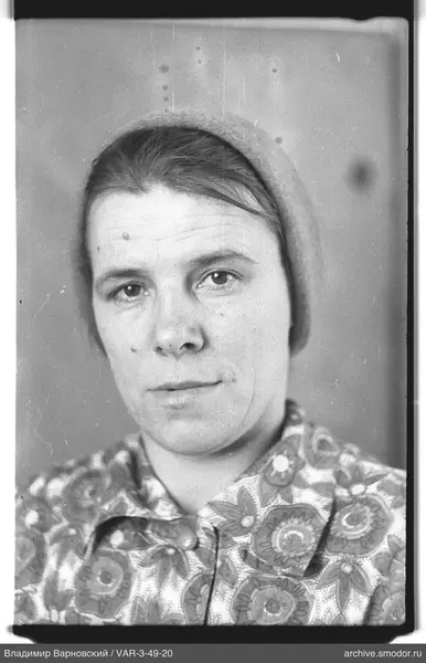 Portrait of a woman with headscarf and floral shirt