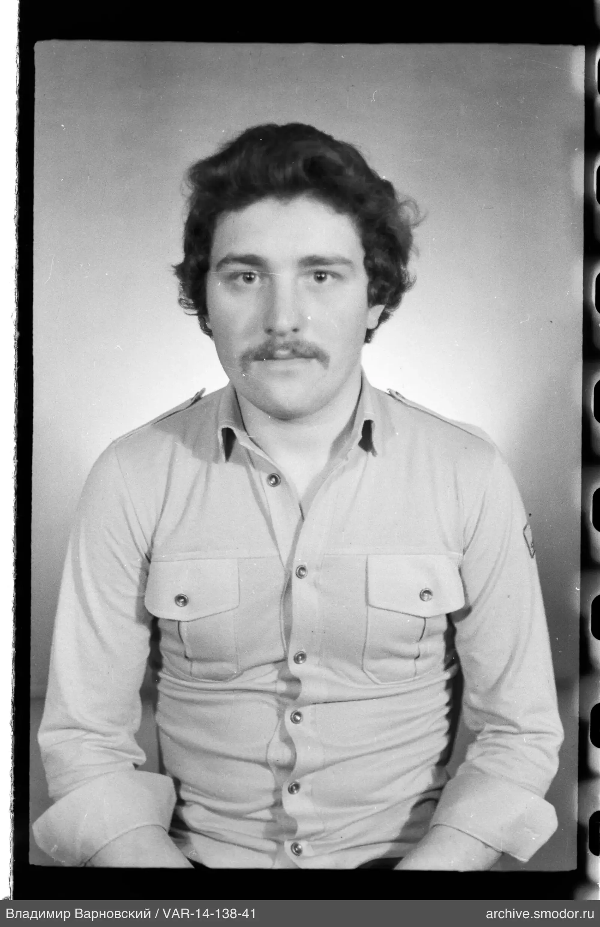 Portrait of a man with a mustache and wavy hair