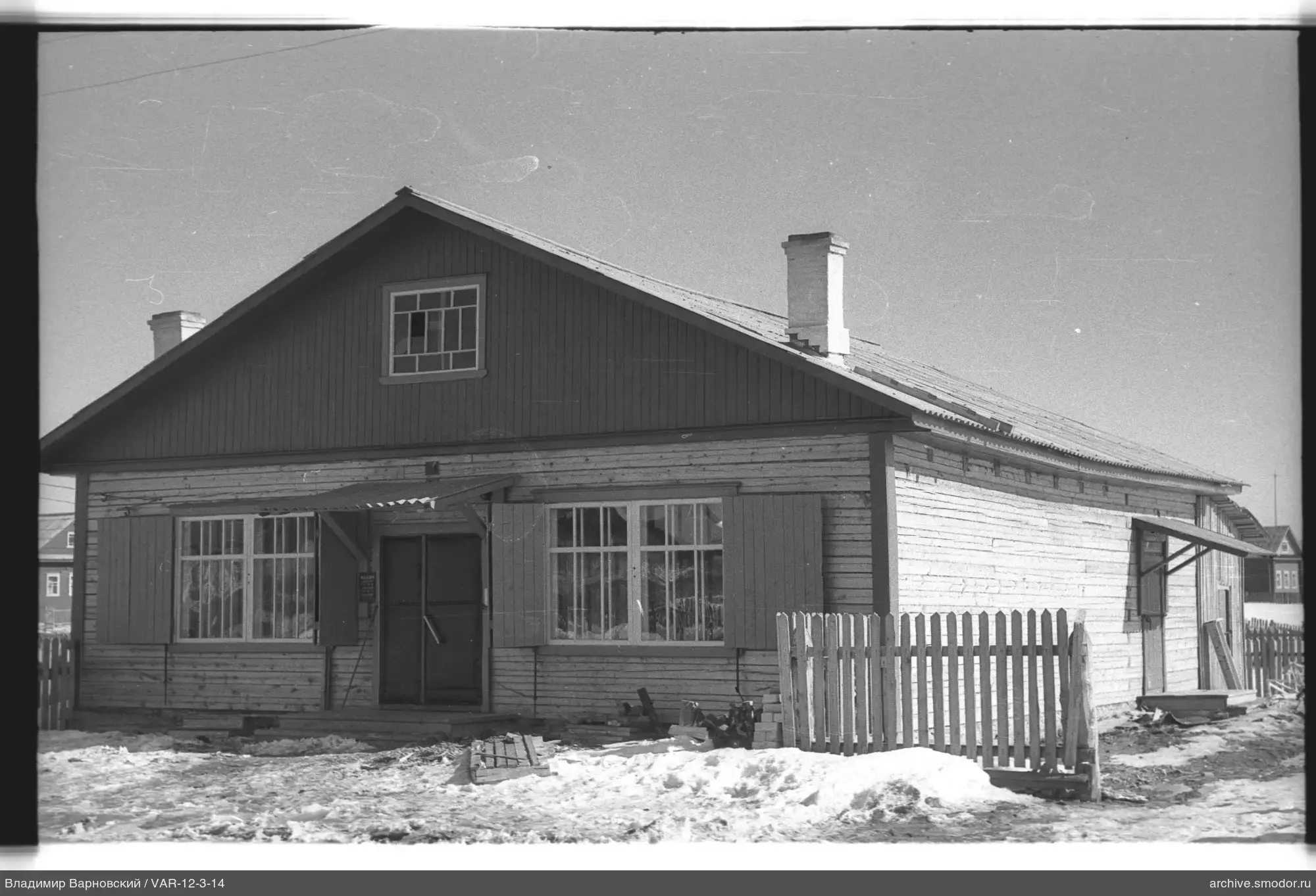 One-story wooden building with windows and door