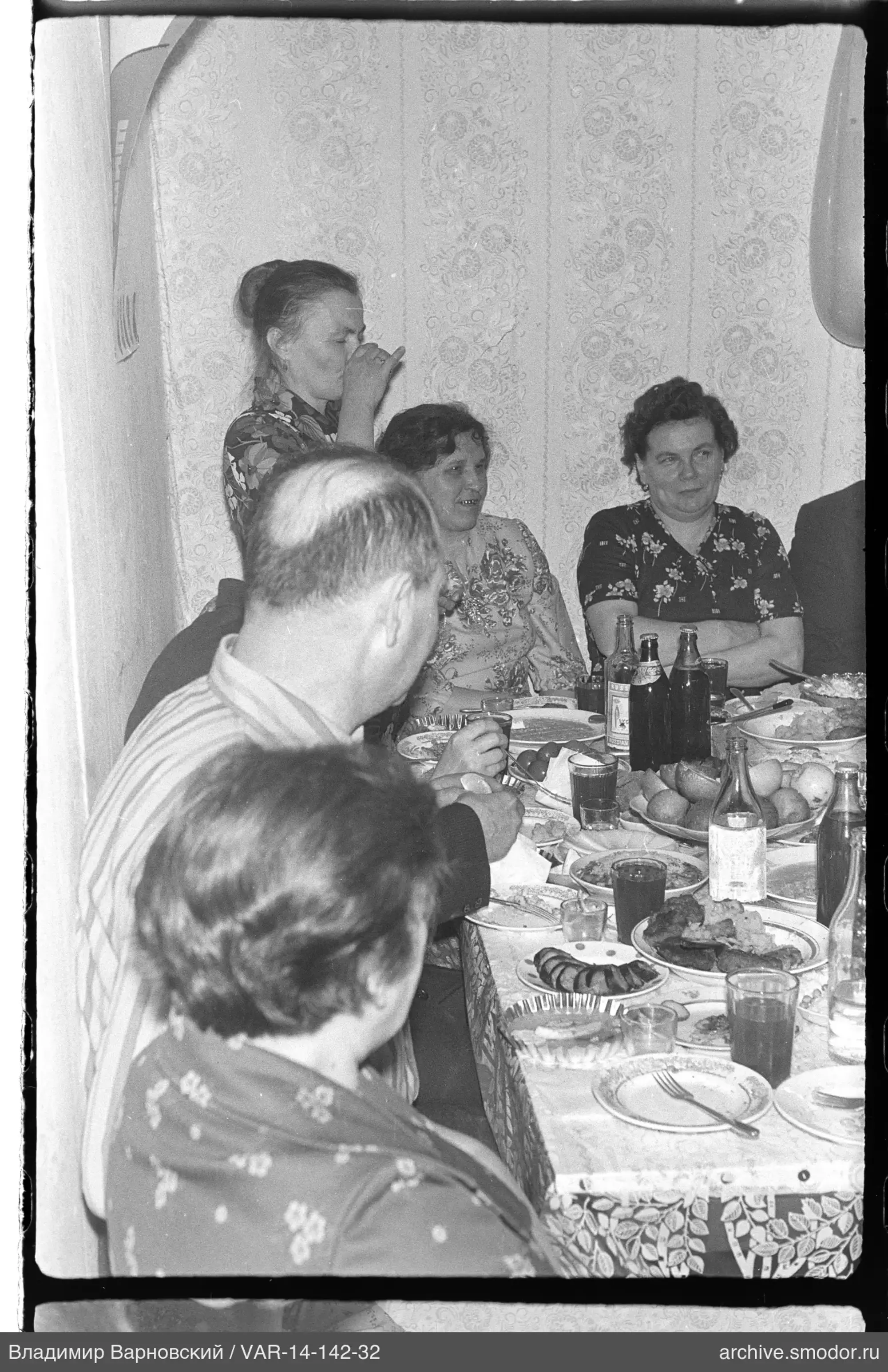 People sitting at a table with food and drinks