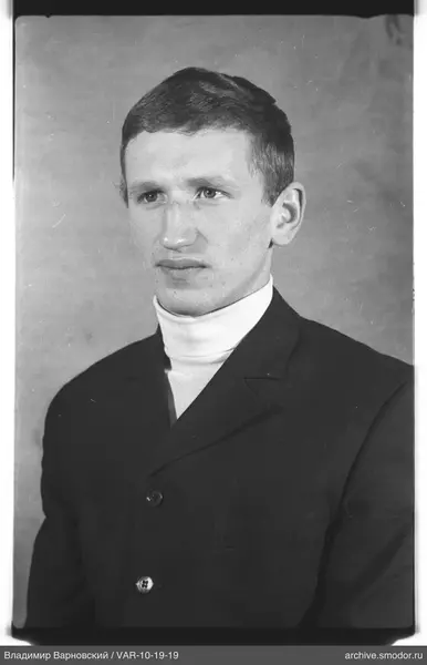 Portrait of a man in a dark jacket and turtleneck