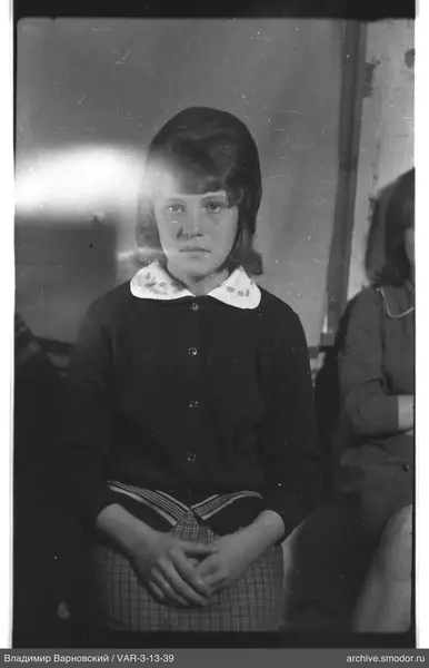 Portrait of a girl with cardigan and checkered skirt