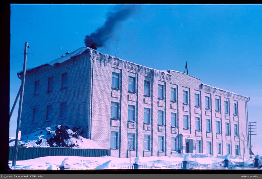 Three-story brick building with smoke
