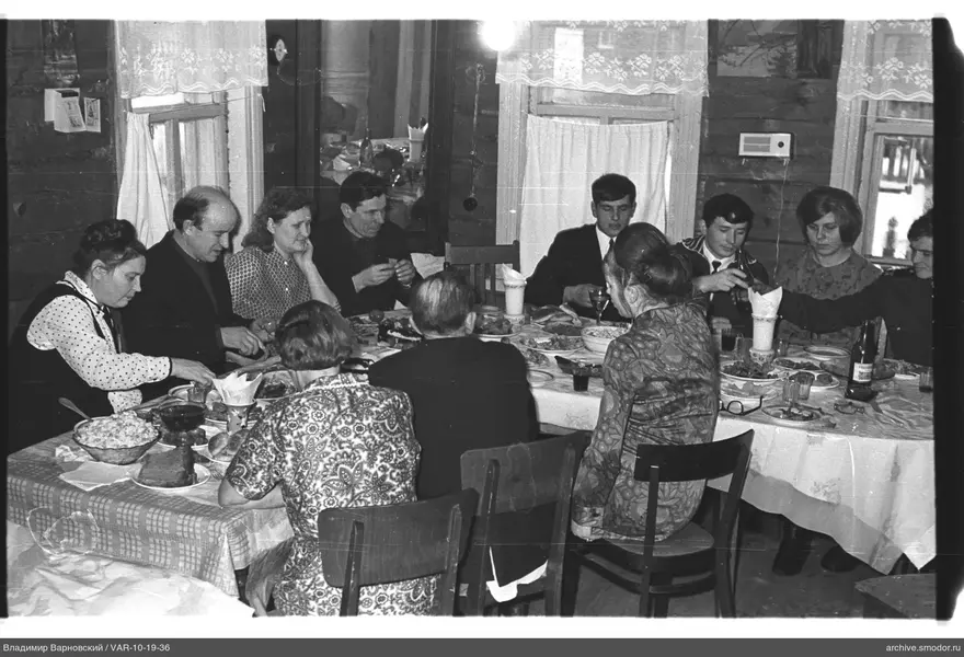 Group of people at a table with food and drinks