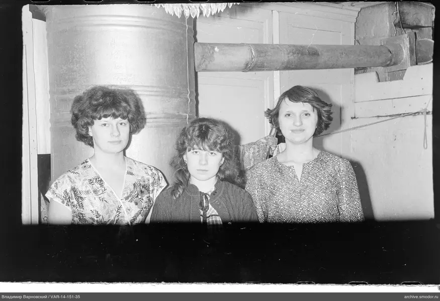 Group portrait of three women indoors