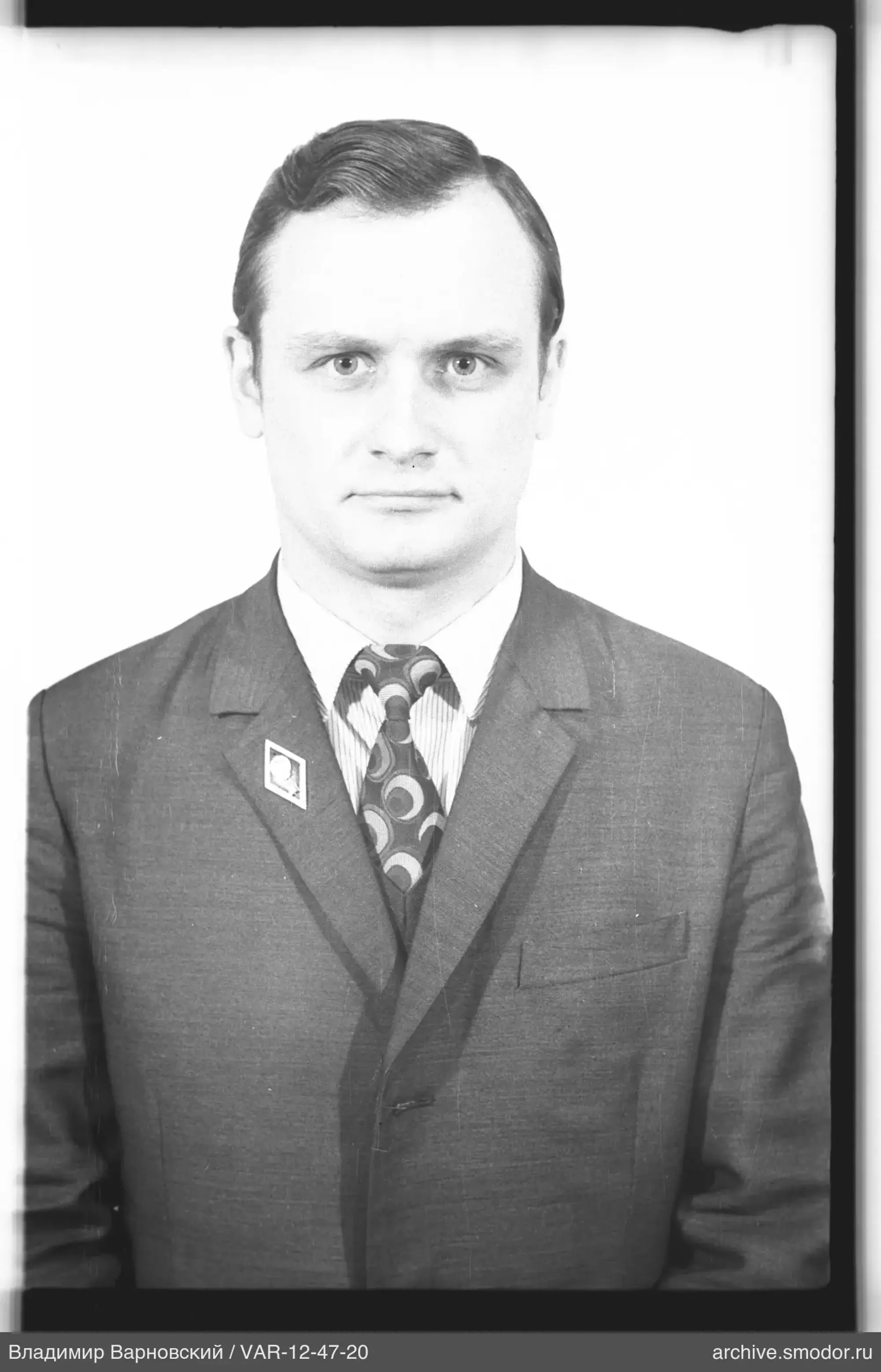 Portrait of a man in a suit with badge