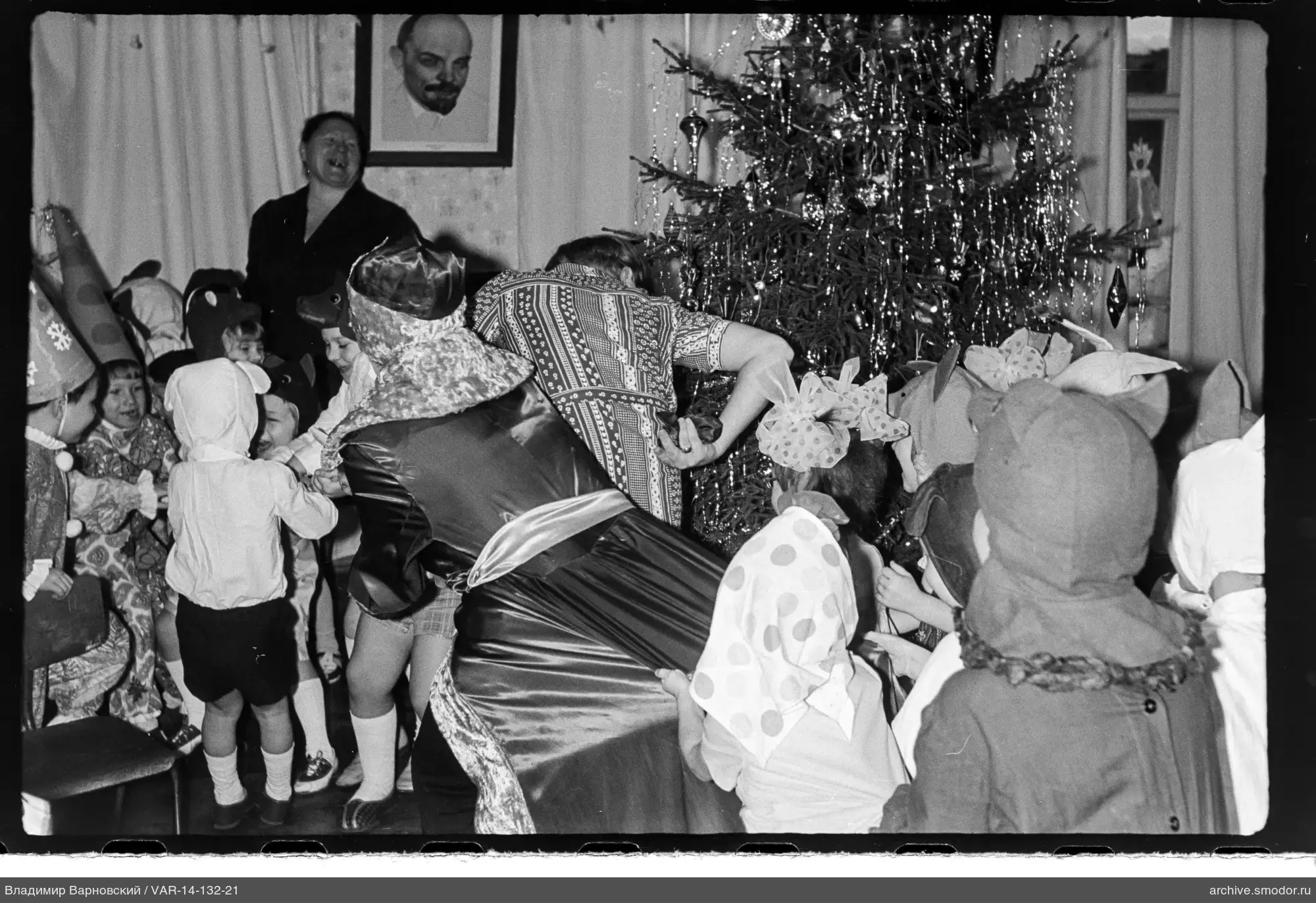 Kinder mit Frauen um geschmückten Weihnachtsbaum