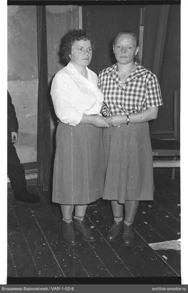 Two women holding hands