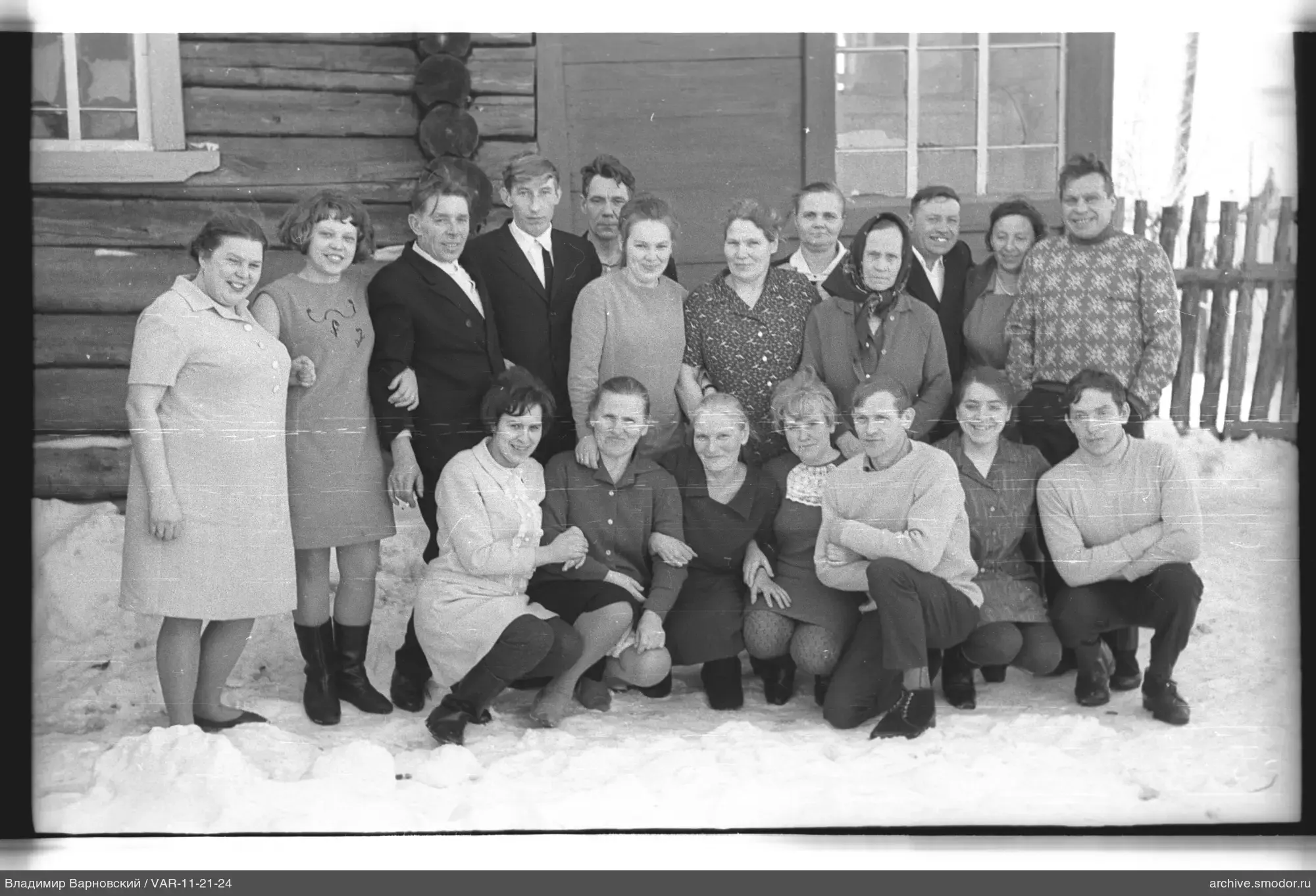 Group portrait on snow in front of a house