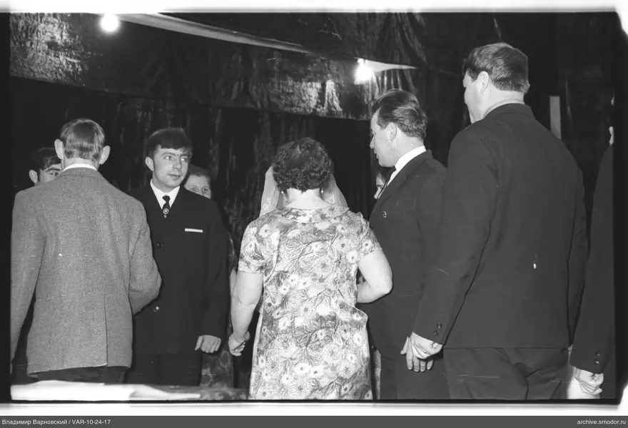 Group of people in a room with curtain