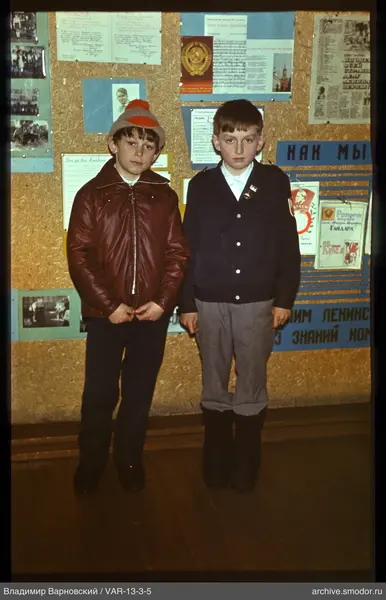 Two boys standing in front of an information board
