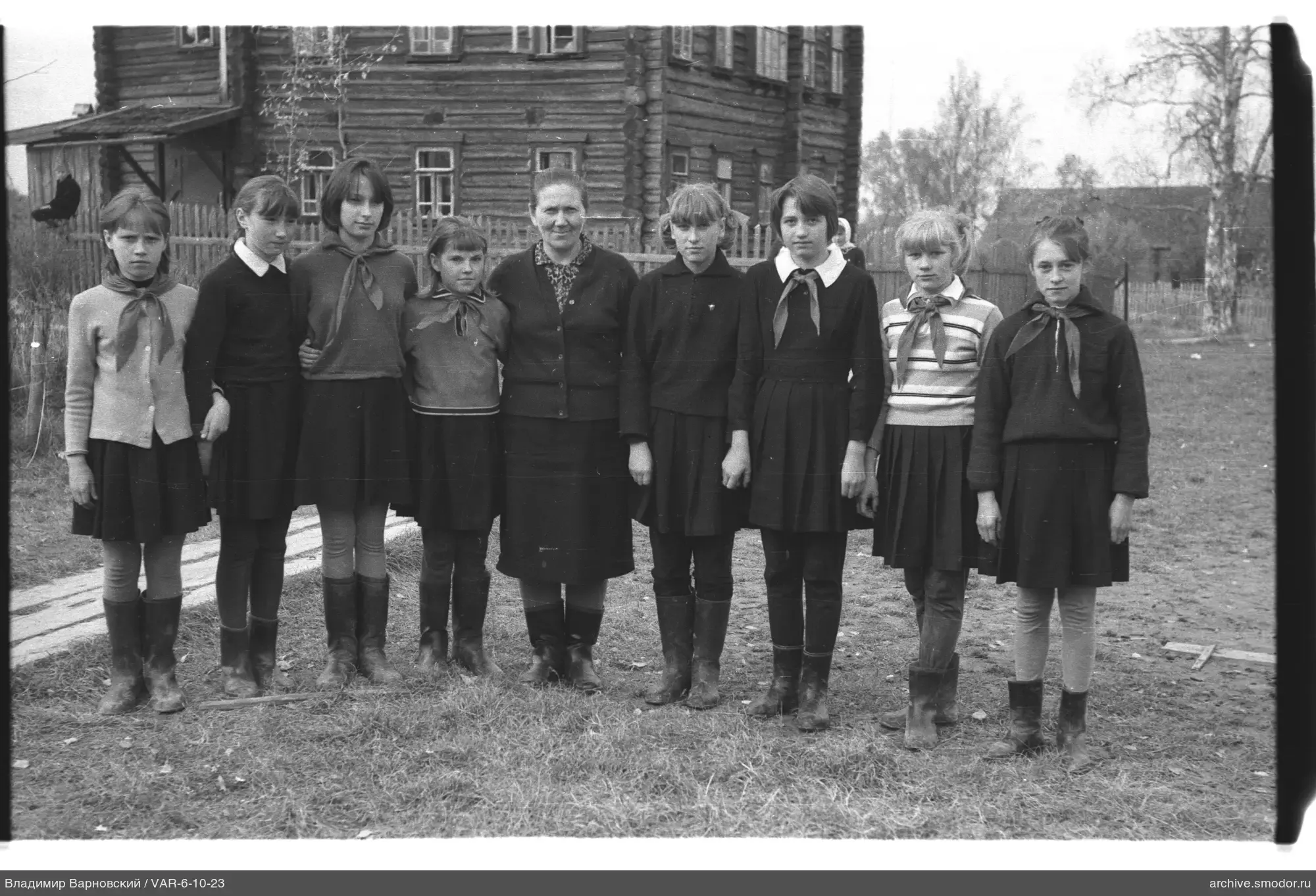 Group portrait of girls and woman on grass