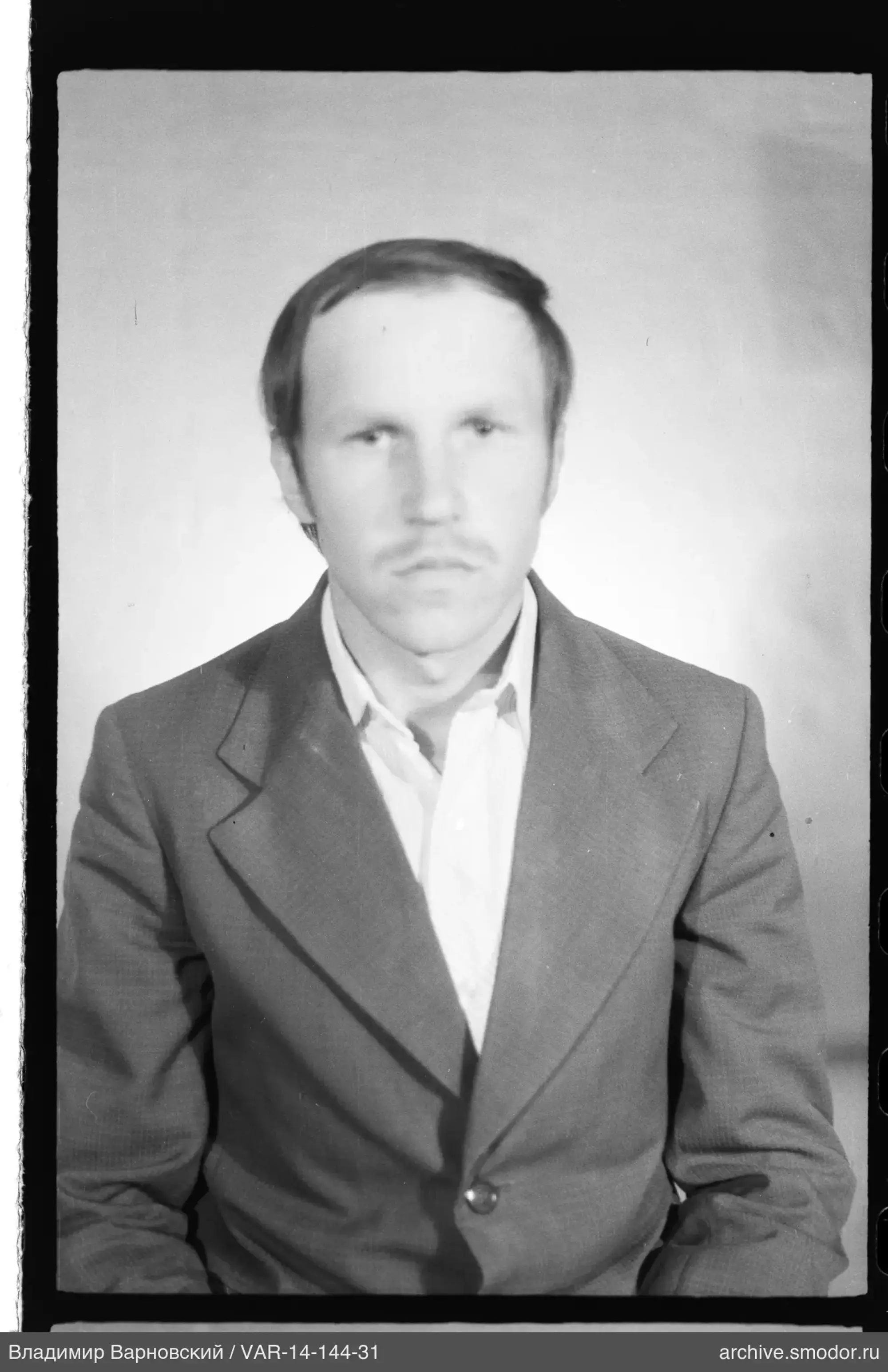 Portrait of a man in a light shirt and dark jacket