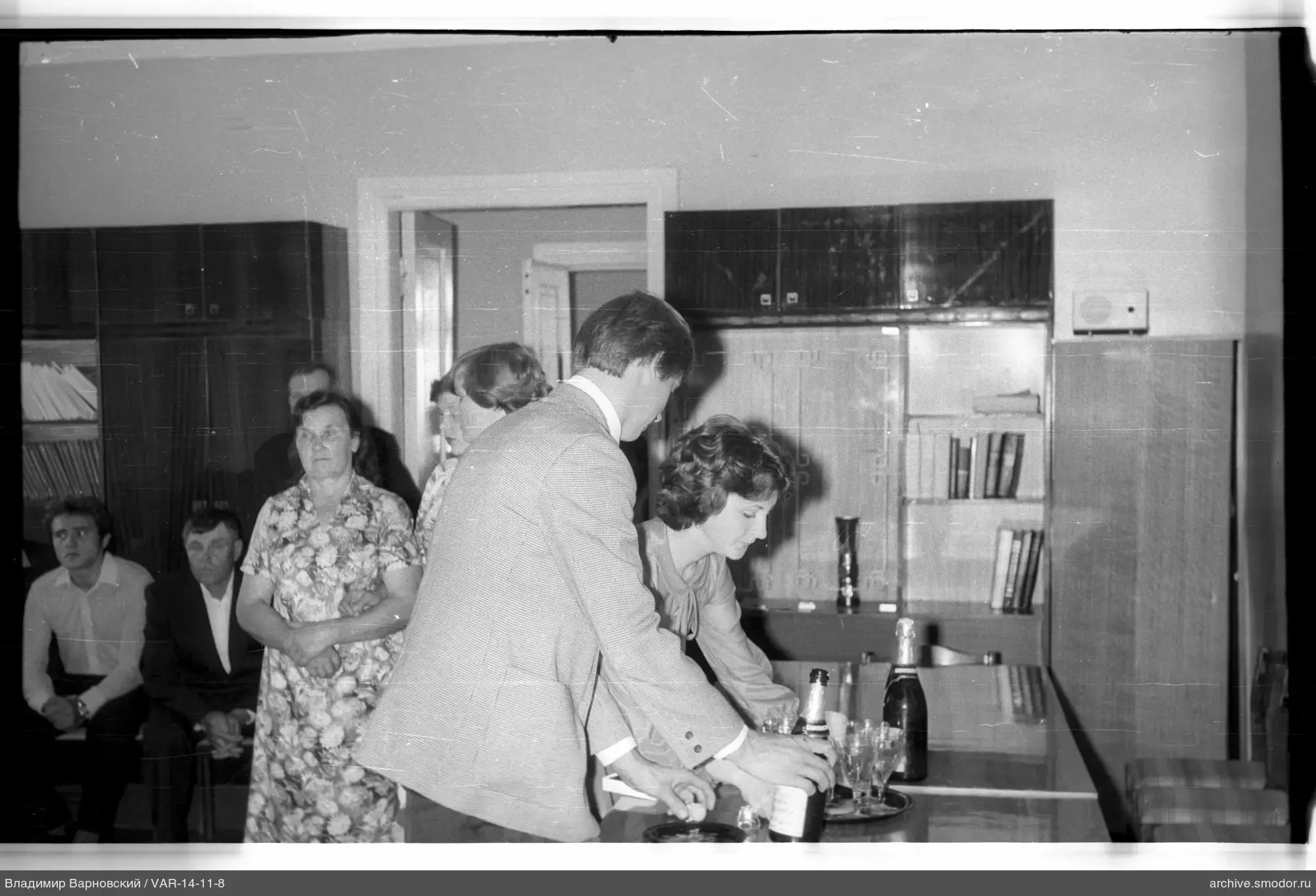 People leaning over a table at an event