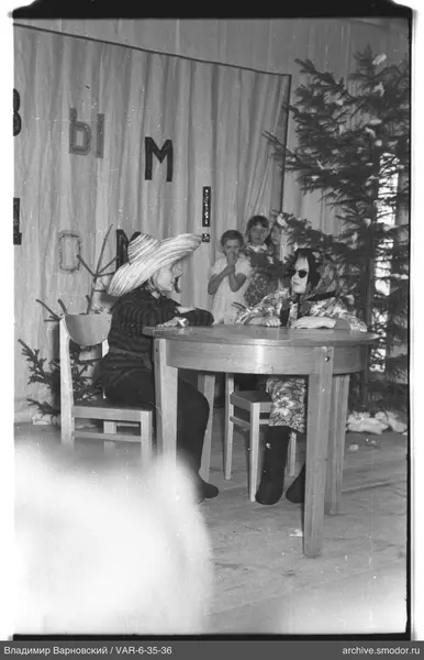 Two children sitting at a round table