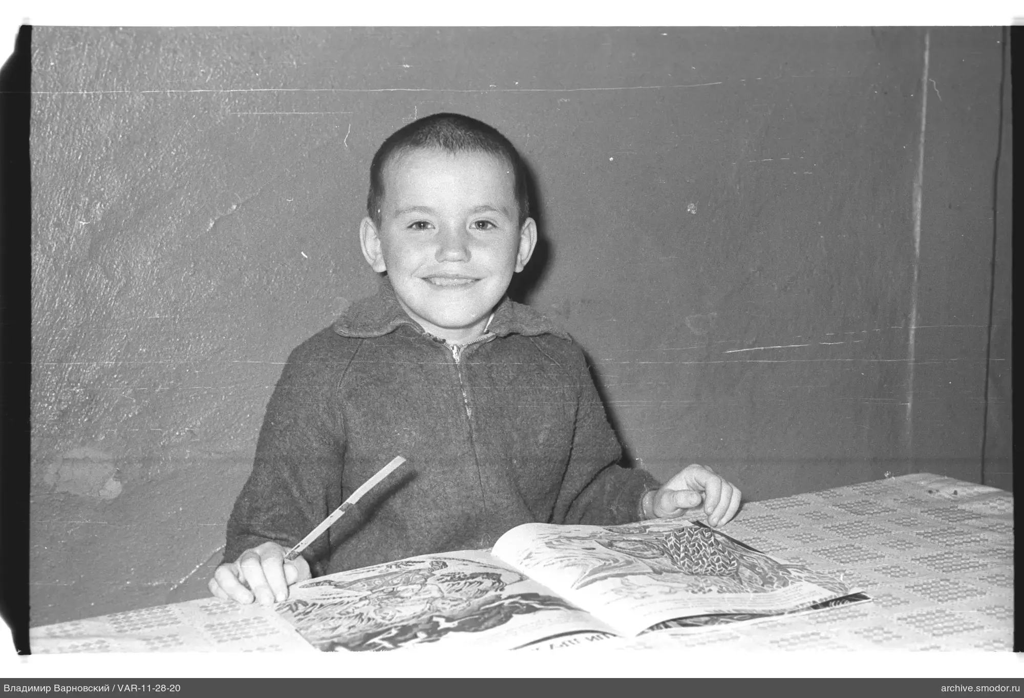 Portrait of a boy with a book and pencil