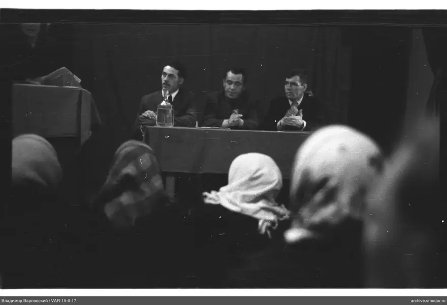 Men sitting at a table during an event