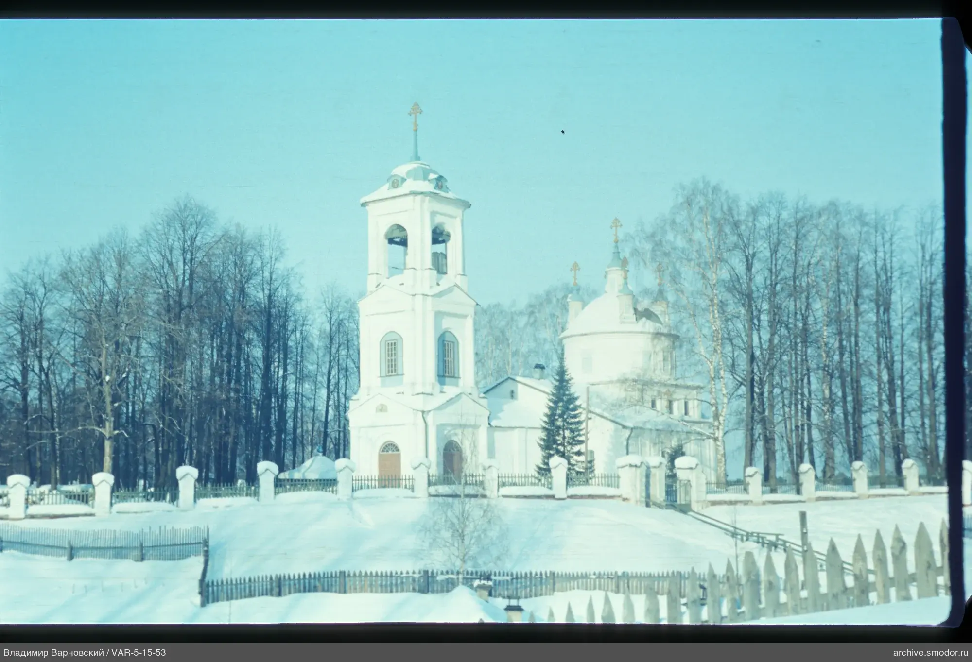 White church with domes and bell tower