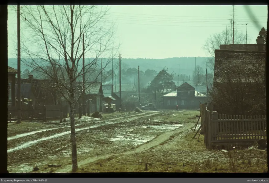 Village dirt road with person in red