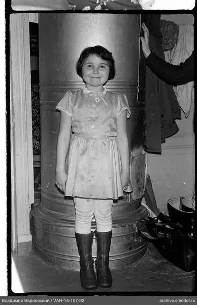 Girl standing in front of a metal stove