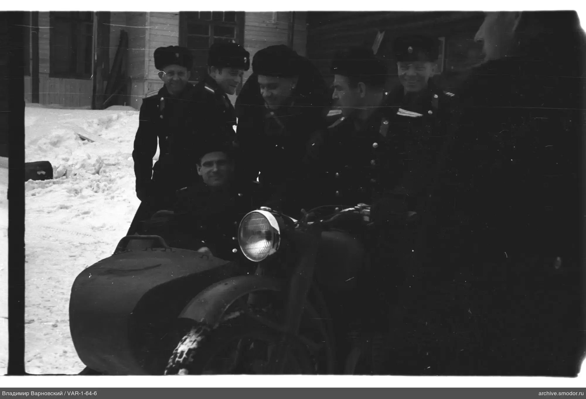 Group of men in military uniform with motorcycle and sidecar