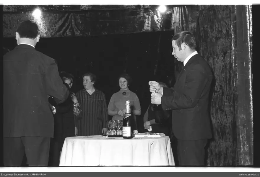 Man opening champagne at an event