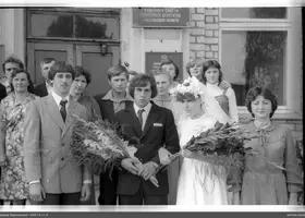 Group portrait with woman in white dress