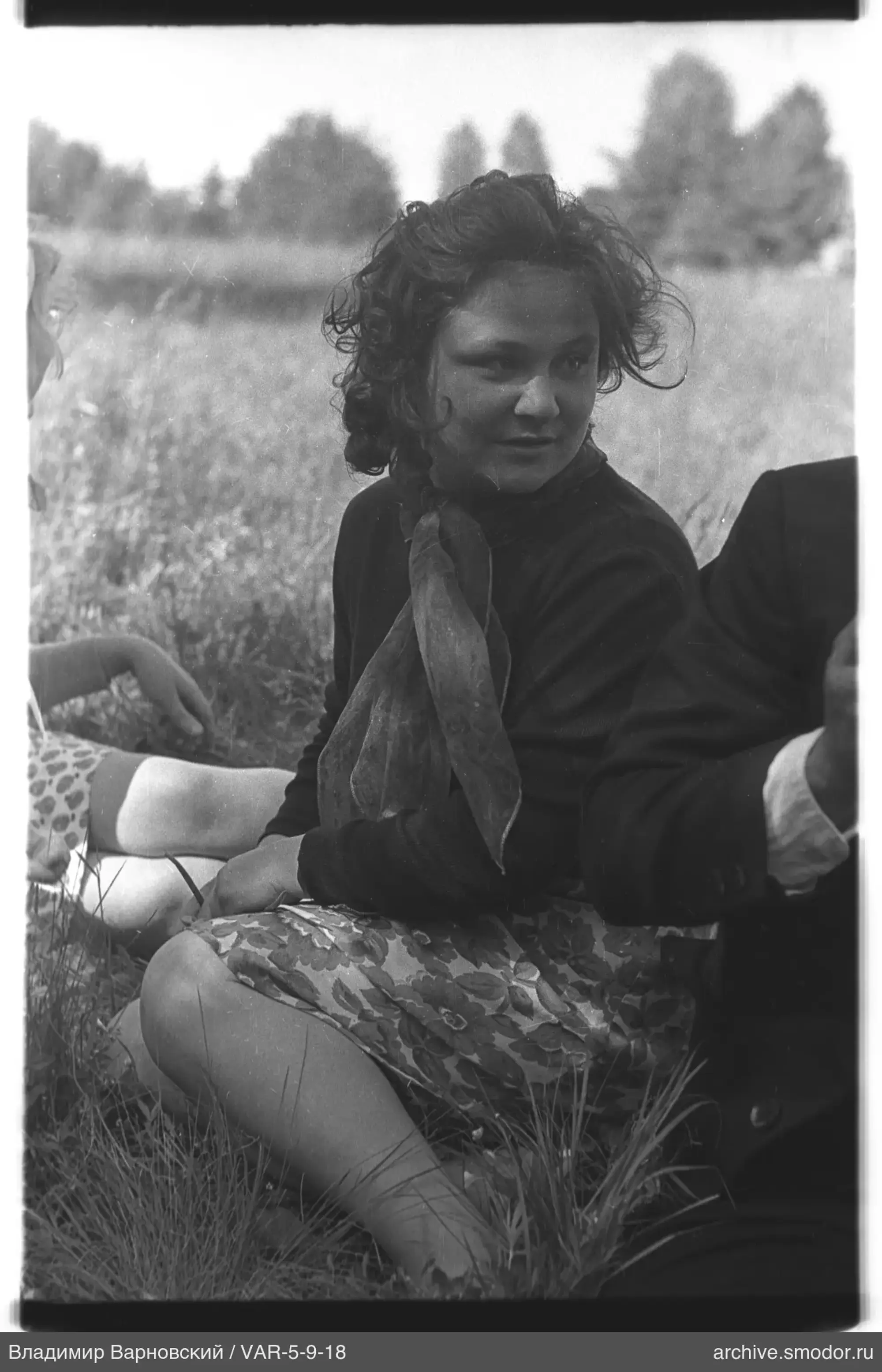 Profile portrait of a woman sitting on grass