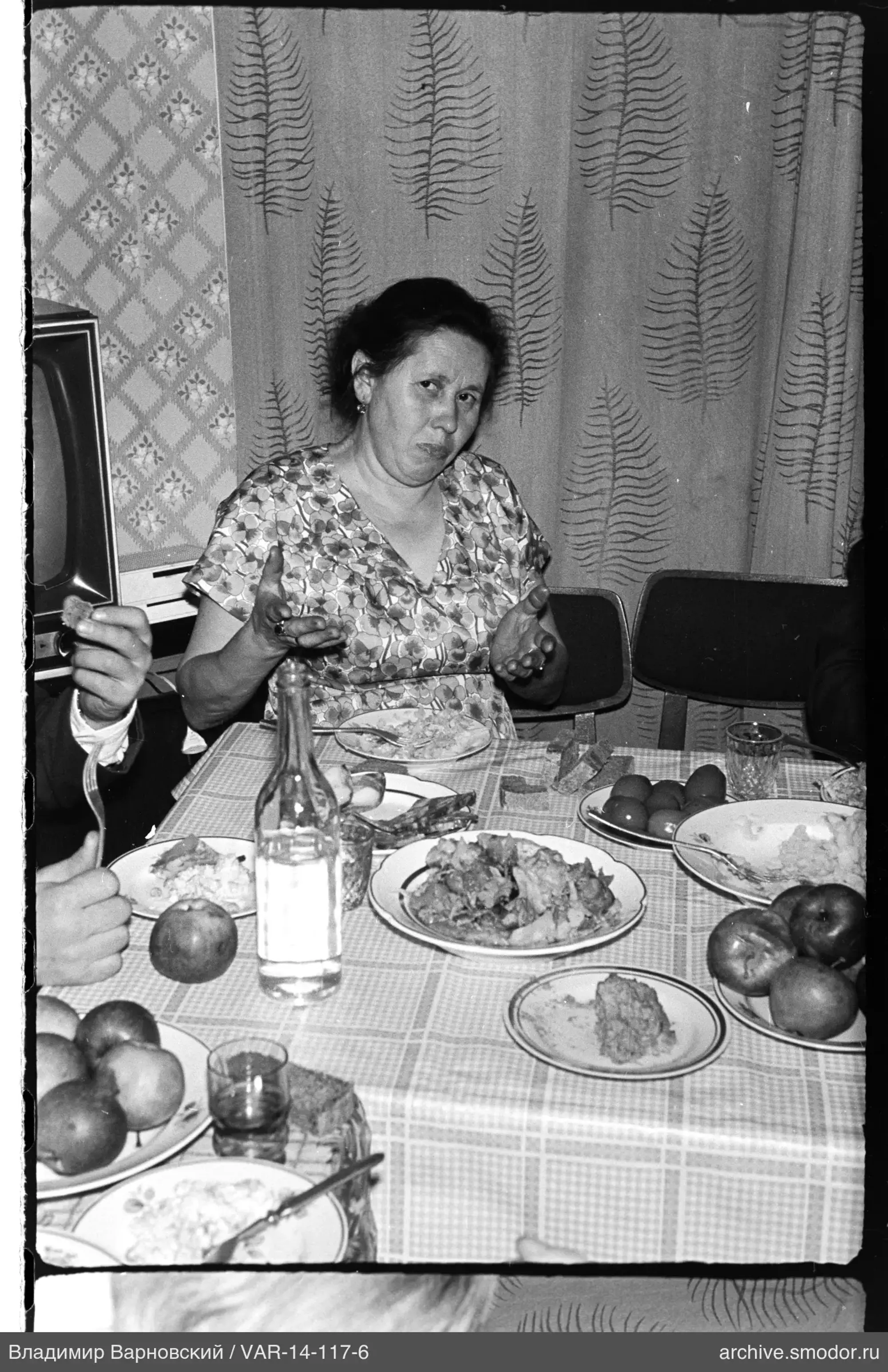 Woman at a table with food and gestures