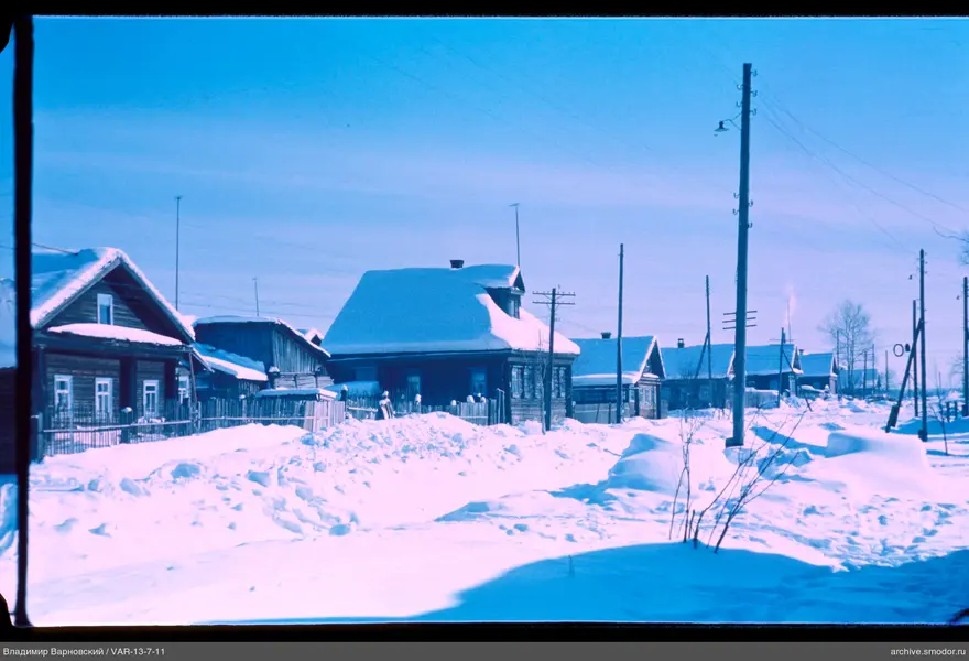 Wooden houses with snow-covered roofs