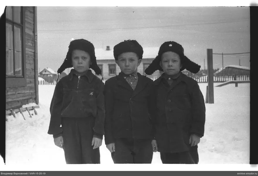 Drei Jungen in Ushankas im Schnee