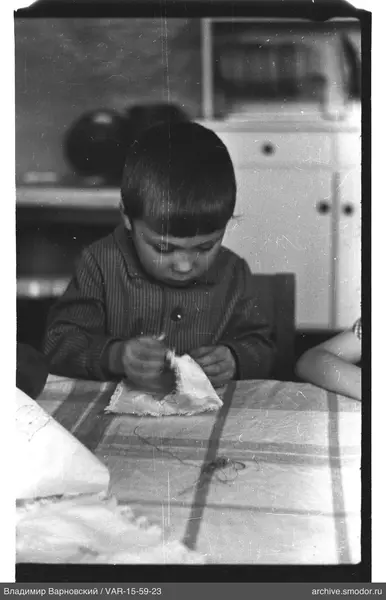 Child with needle at table