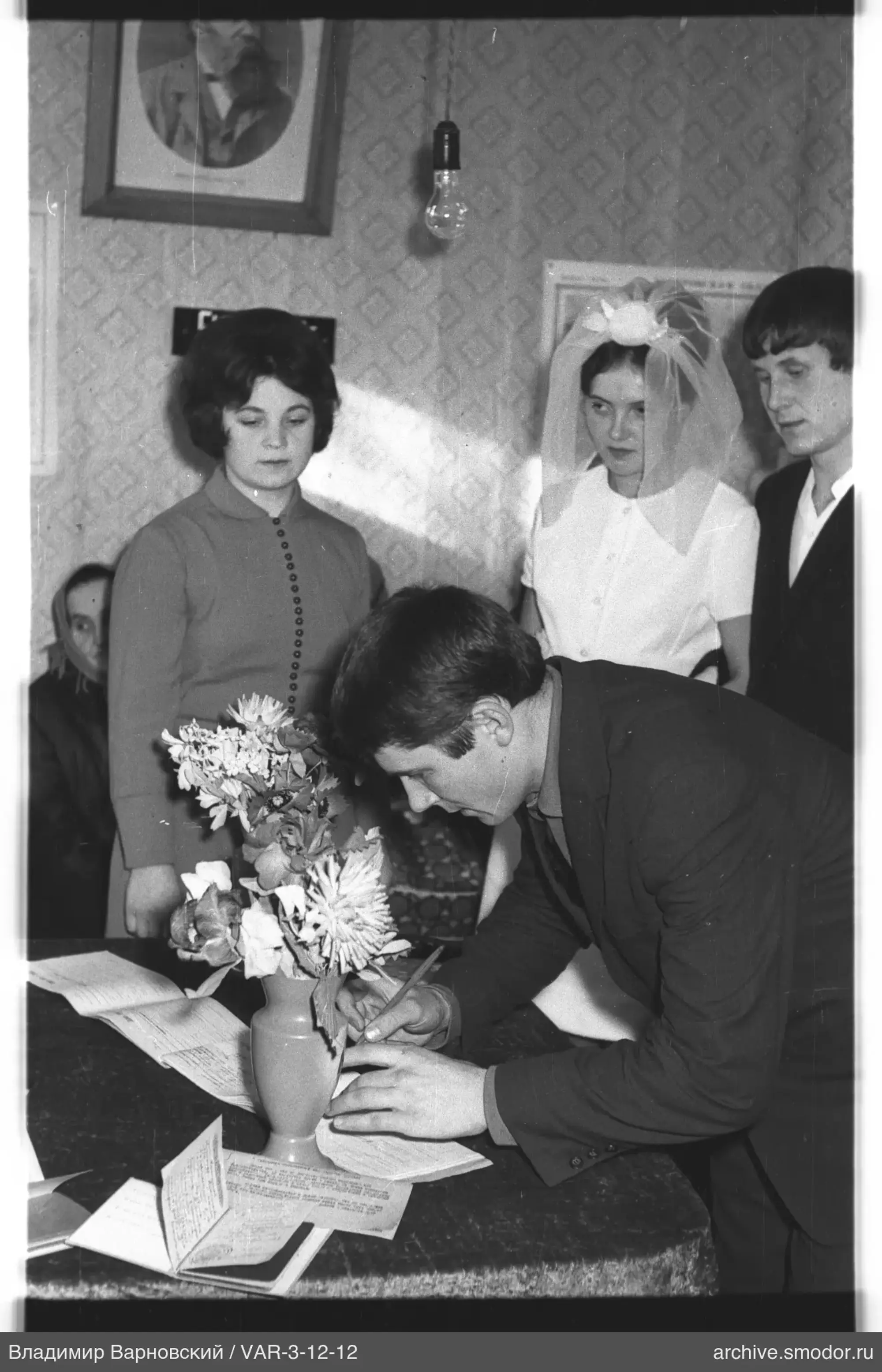 Man signing documents at an event