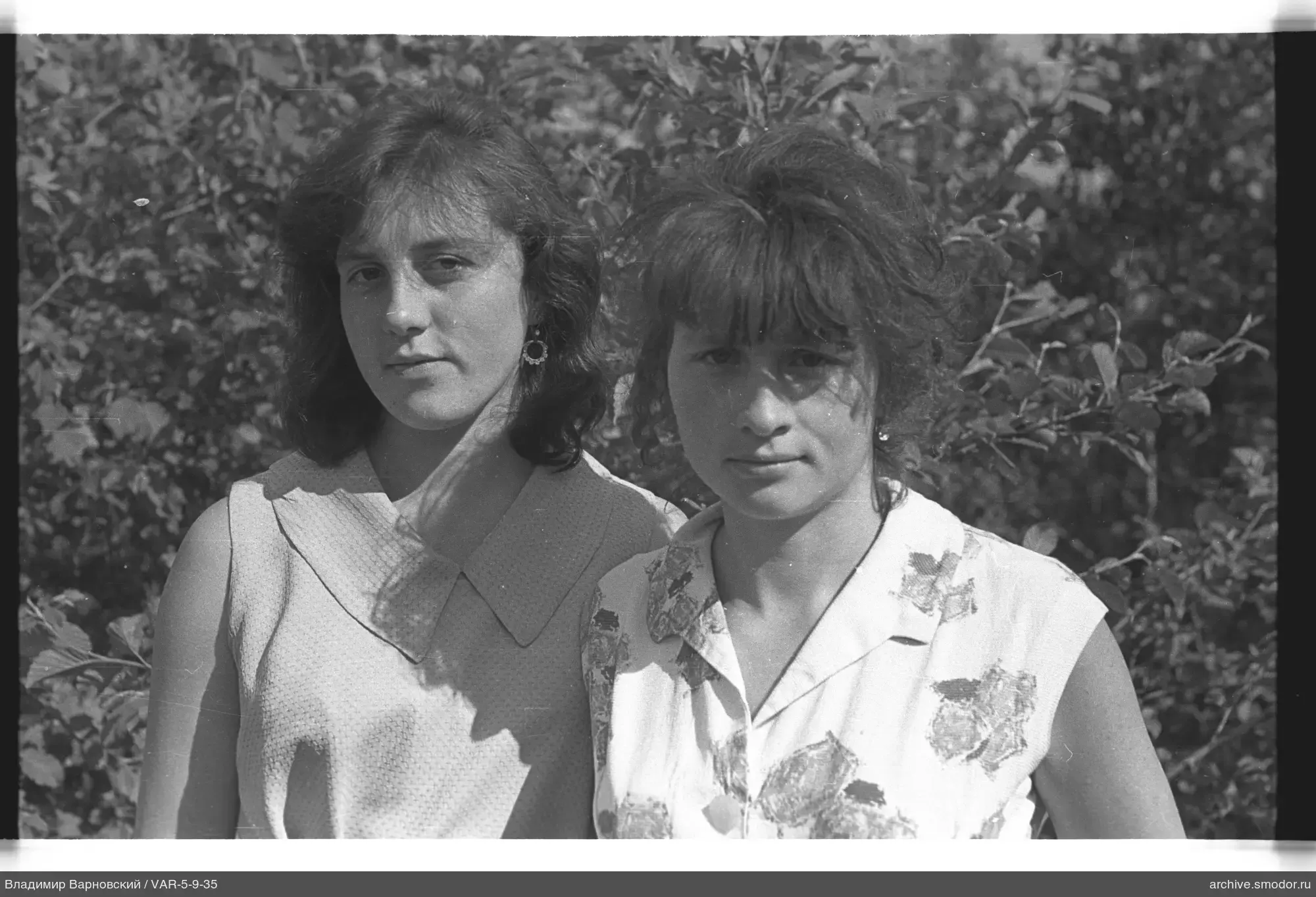 Portrait of two women against foliage