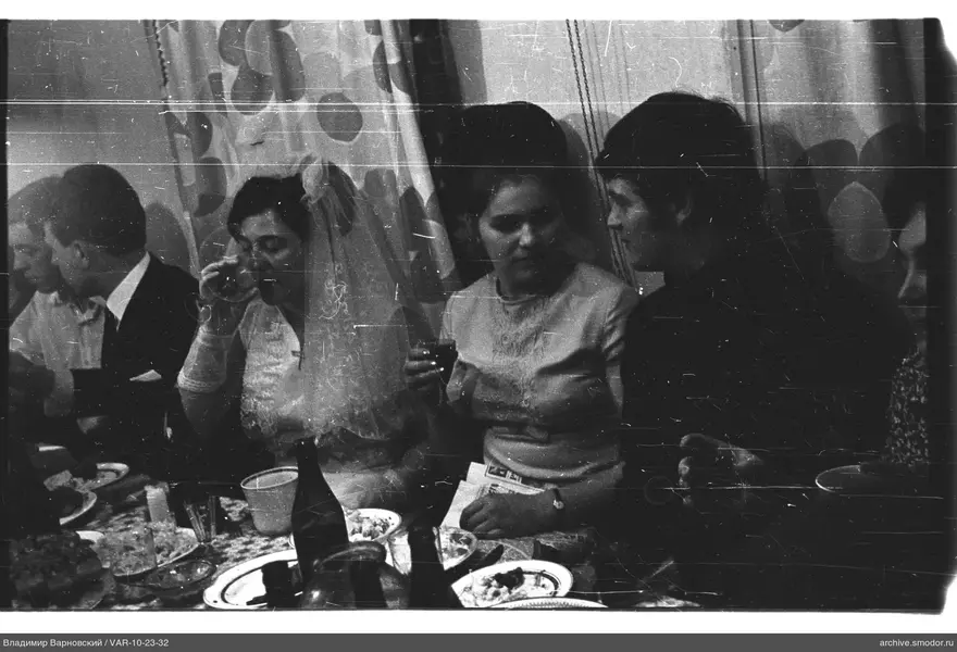 Group at a table, woman in wedding dress