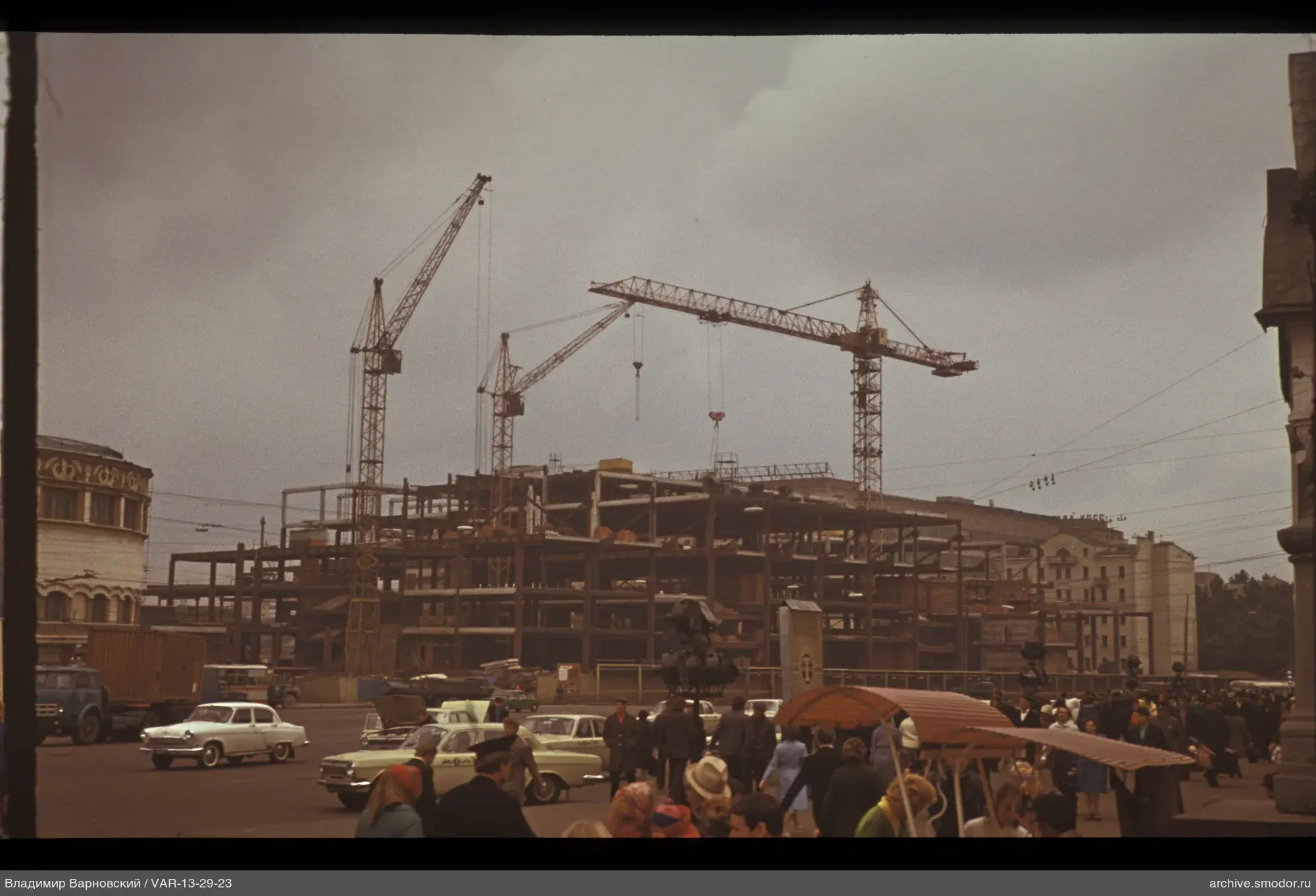 Street with moving cars and construction site