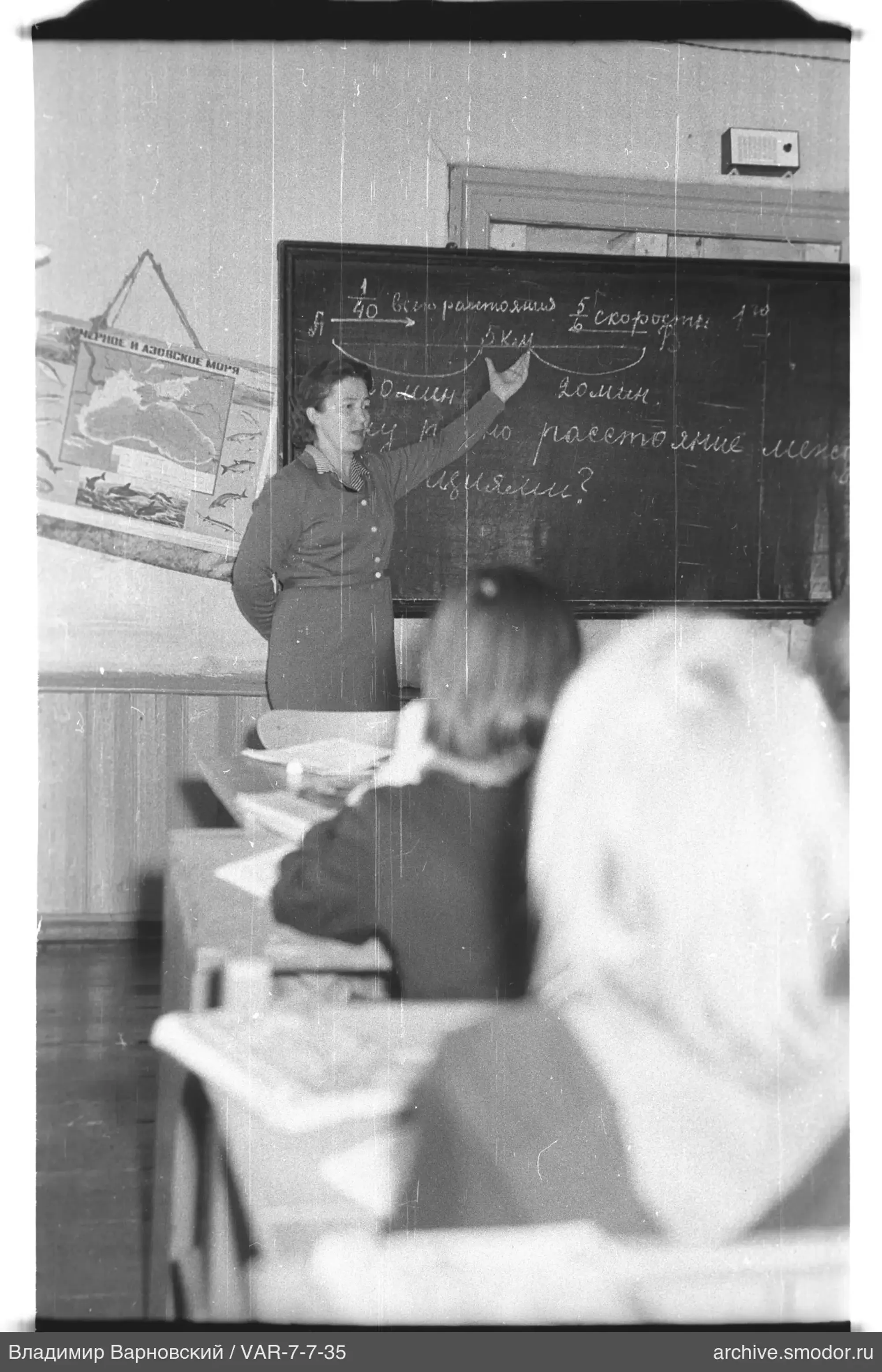 Teacher at blackboard with students