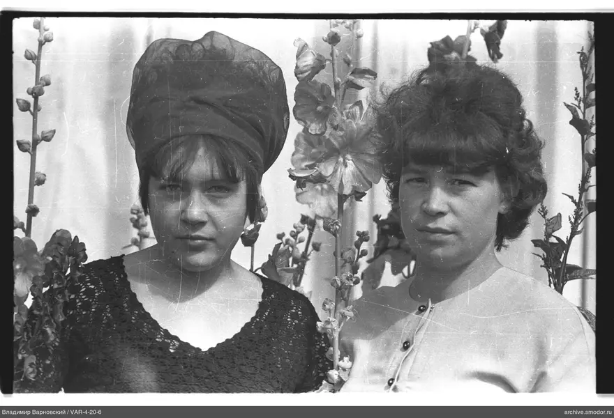 Two women against flowering plants