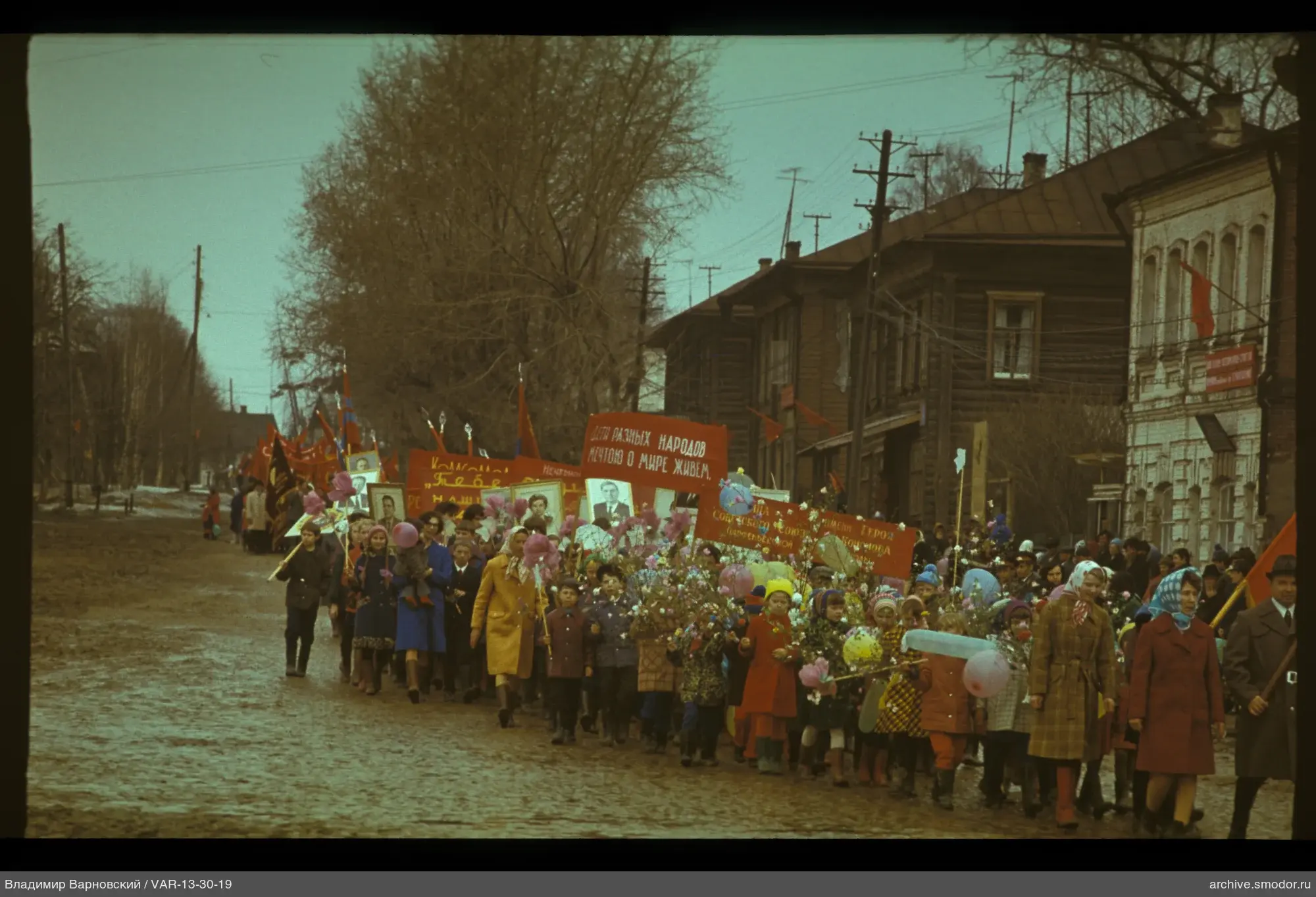 Gruppe von Menschen auf Straße mit Plakaten und Flagge