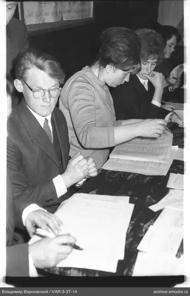 People sitting at a table with papers