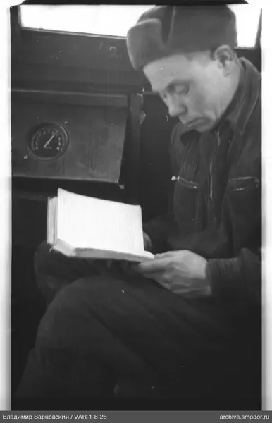 Man reading a book with instrument panel